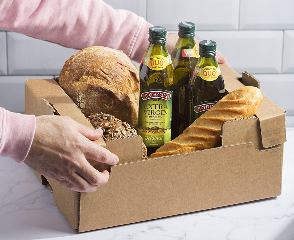 Some products such as olive oil bottle ans some bread in a box