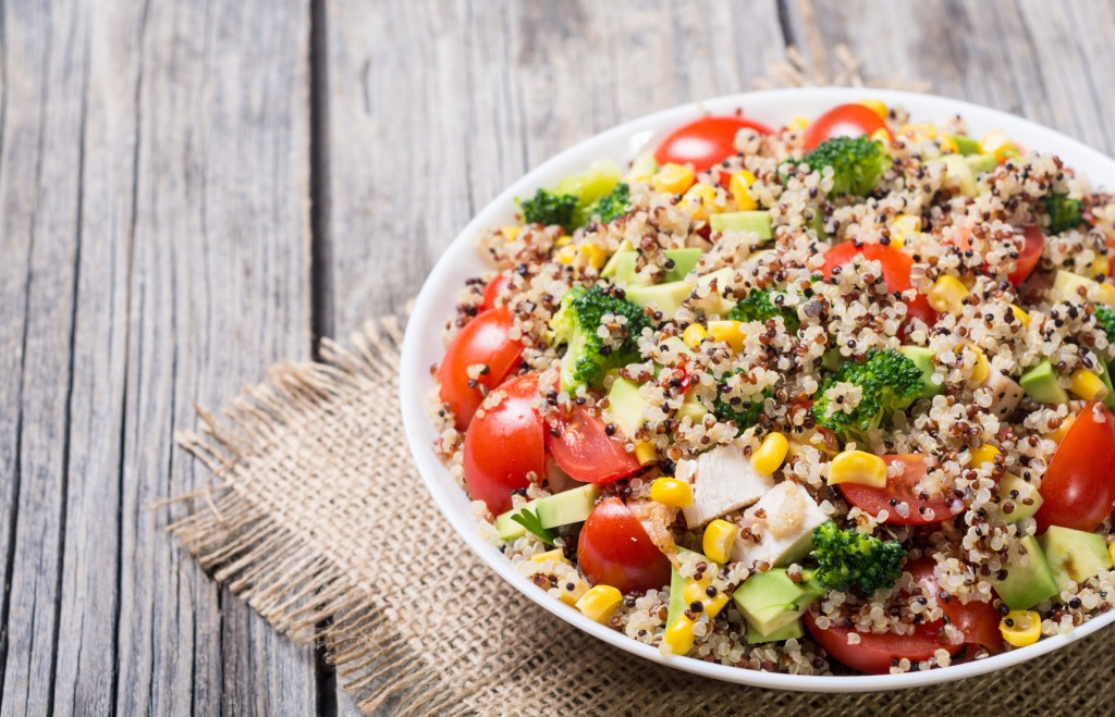 Multicoloured salad with tomatoes, quinoa, kale and sweet corns