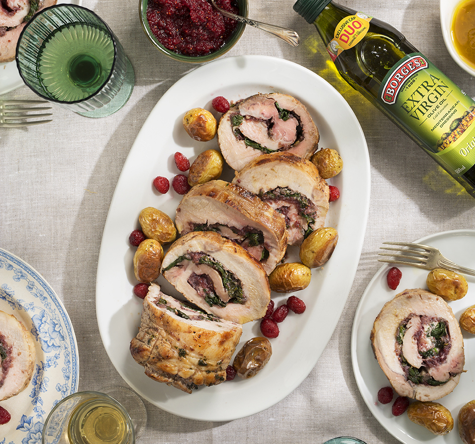 New Year's Eve stuffed pork tenderloin cut and served in a white tray