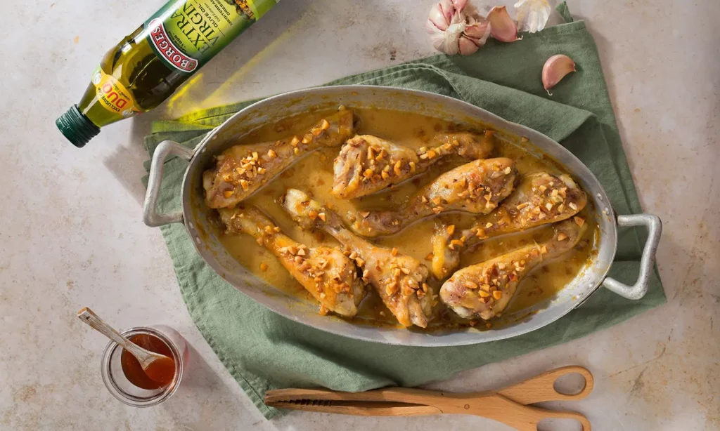 A baked honey mustard chicken recipe served in an oven tray with sauce
