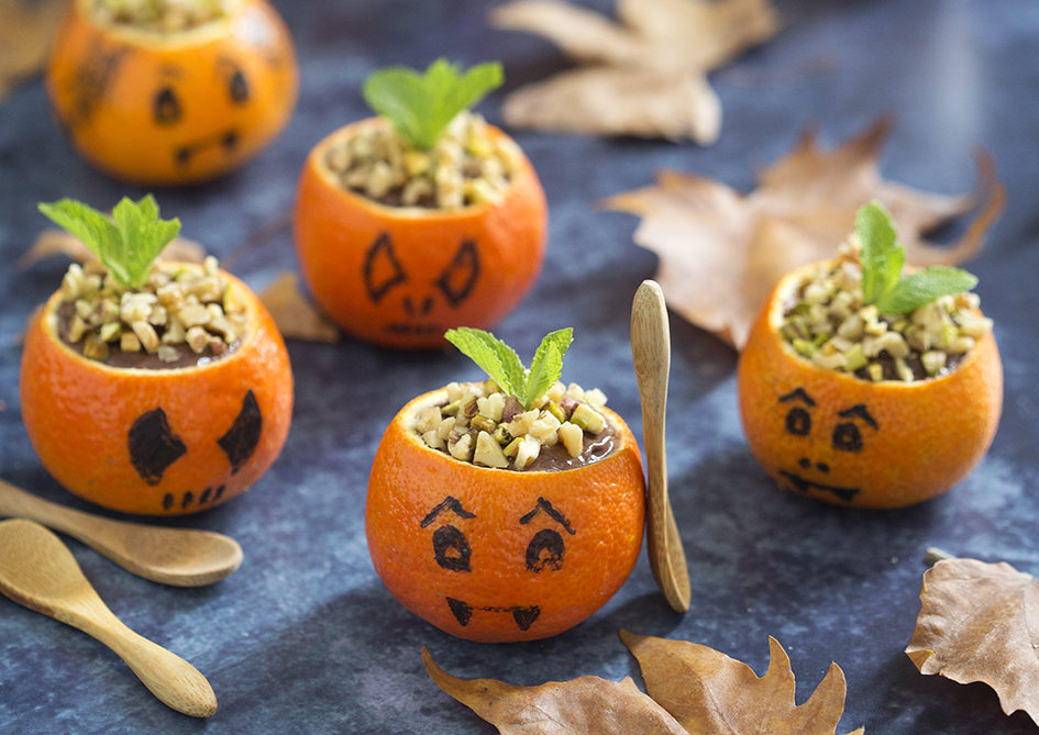 Halloween chocolate mousse served in small mandarine as tiny pumpkins