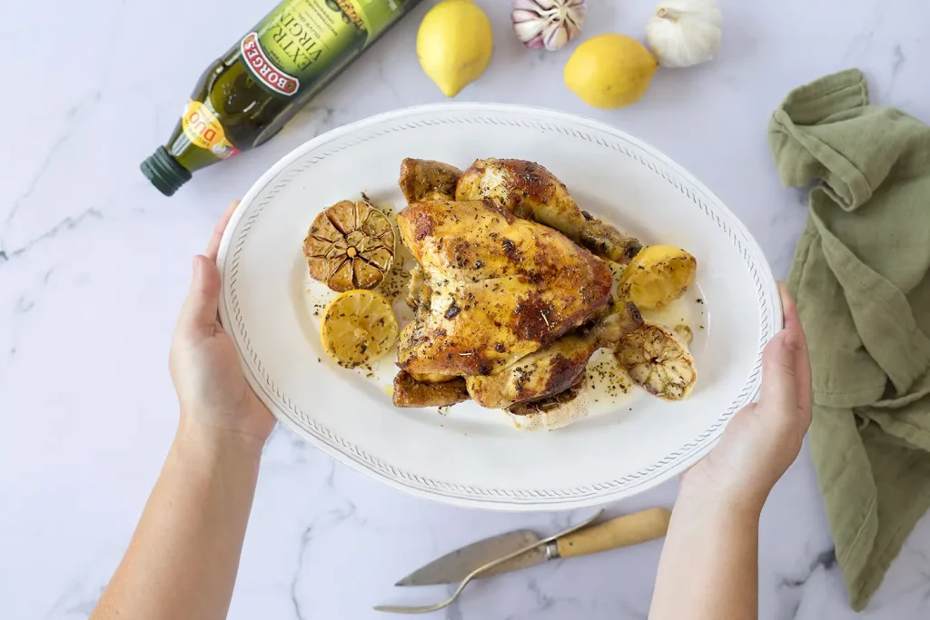Roast chicken recipe served with lemon, garlic and herbs de provence