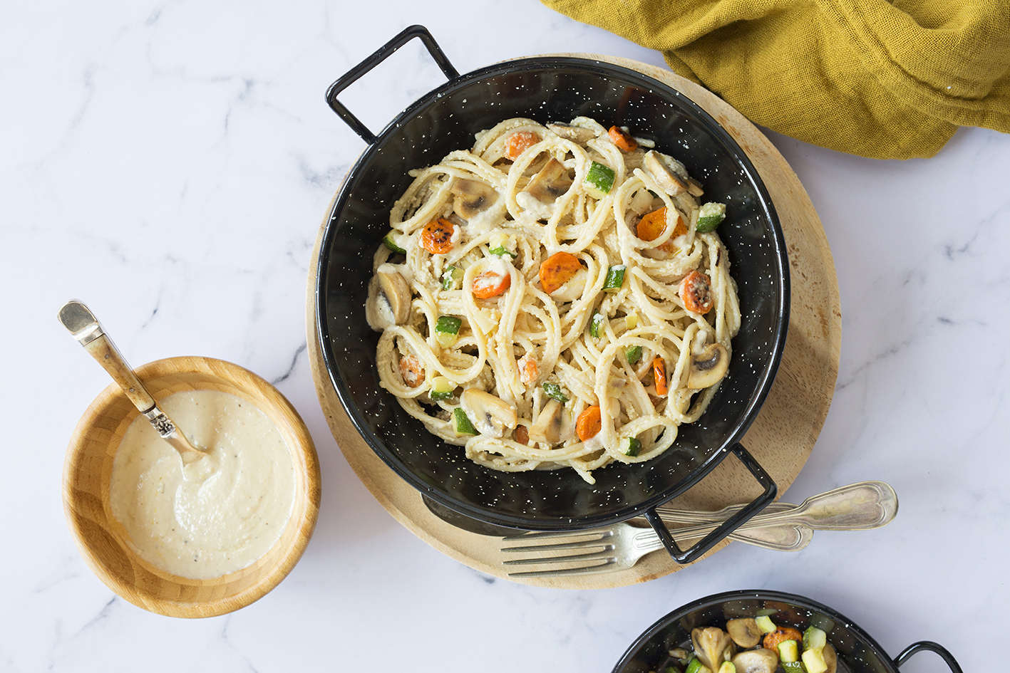 Vegan carbonara pasta spaghetti served in a paella pan