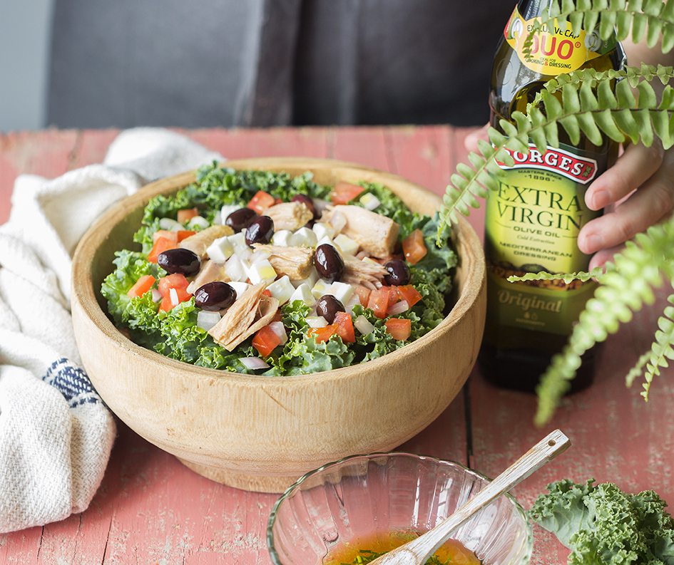 Mediterranean salad with kale served in a wooden bowl